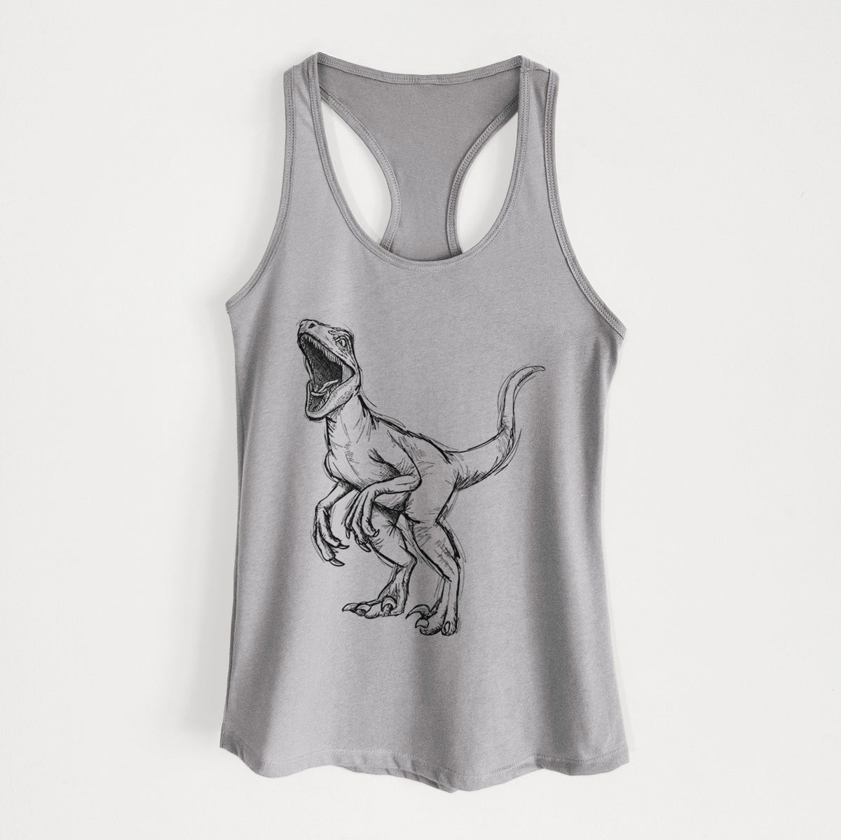 Heather grey women's racerback tank top laid flat, printed with a black ink illustration of a Velociraptor roaring.