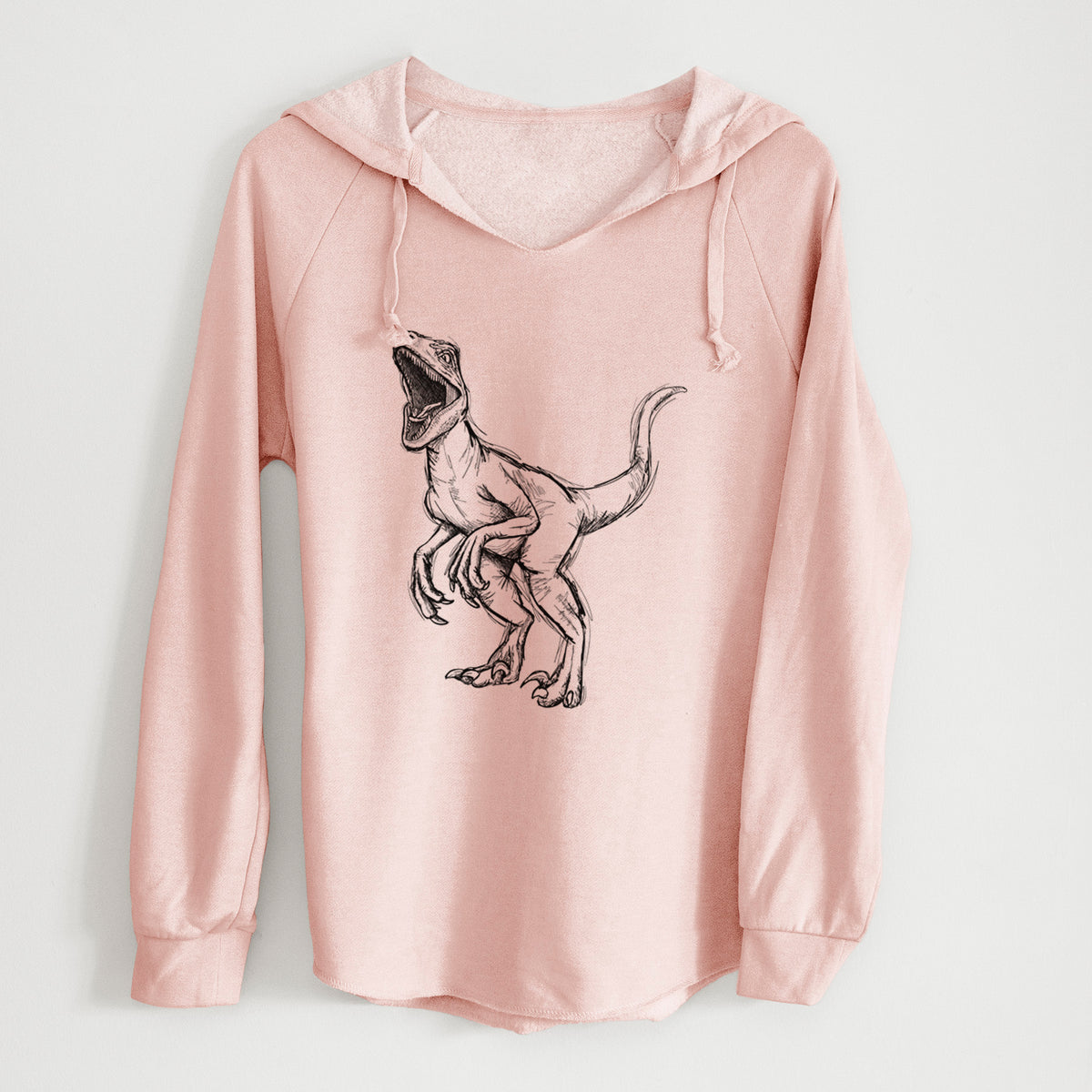 Blush pink women's Cali Wave hooded sweatshirt laid flat, printed with a black ink illustration of a Velociraptor roaring.