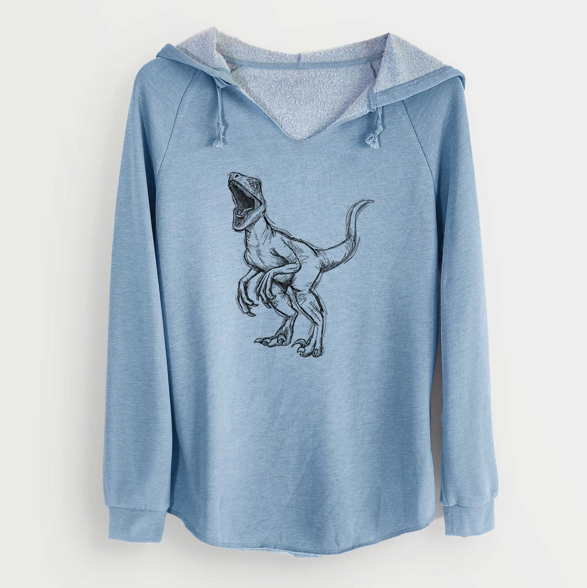 Misty blue women's Cali Wave hooded sweatshirt laid flat, printed with a black ink illustration of a Velociraptor roaring.