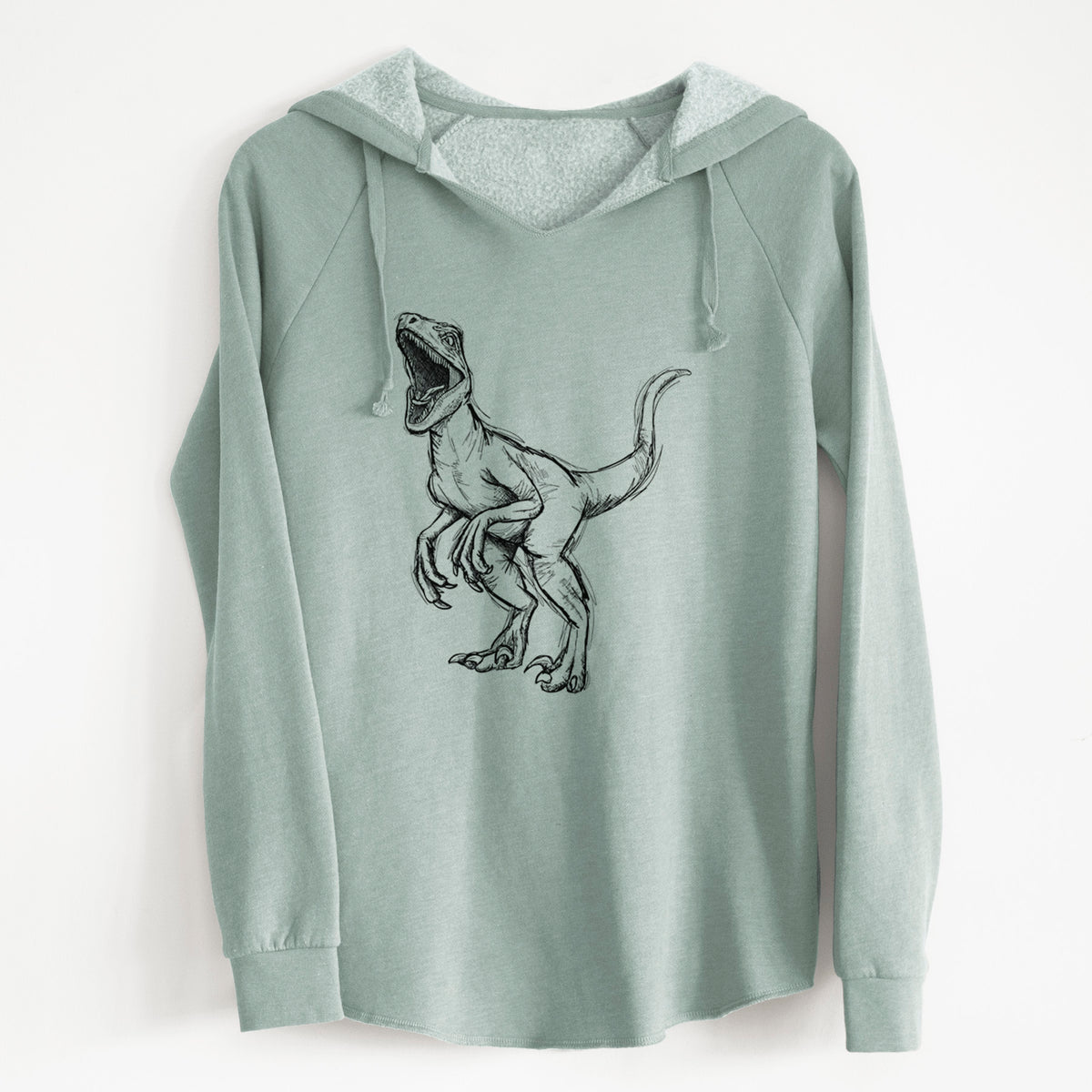 Sage green women's Cali Wave hooded sweatshirt laid flat, printed with a black ink illustration of a Velociraptor roaring.