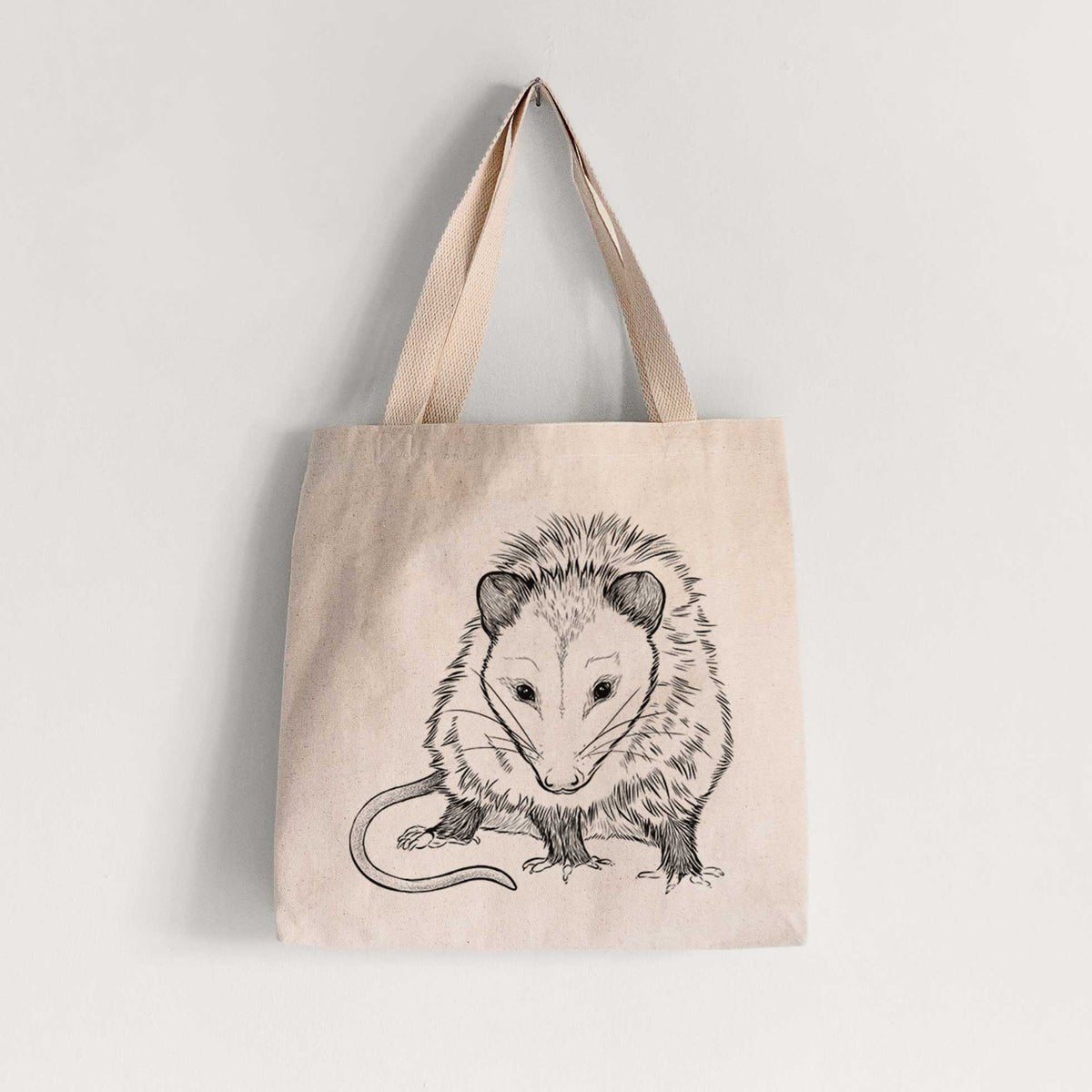 Natural canvas tote bag printed with a detailed black ink illustration of a Virginia opossum standing with its long tail curled.