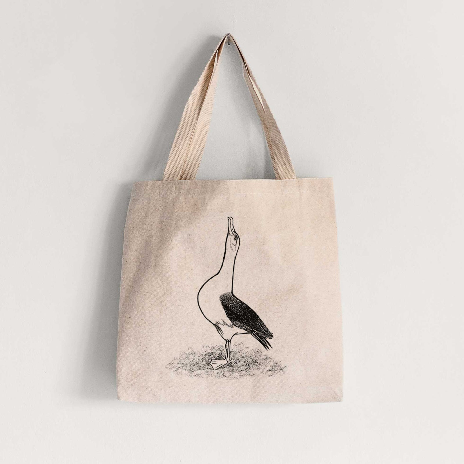 Natural canvas tote bag printed with a black ink illustration of a wandering albatross with its head raised.