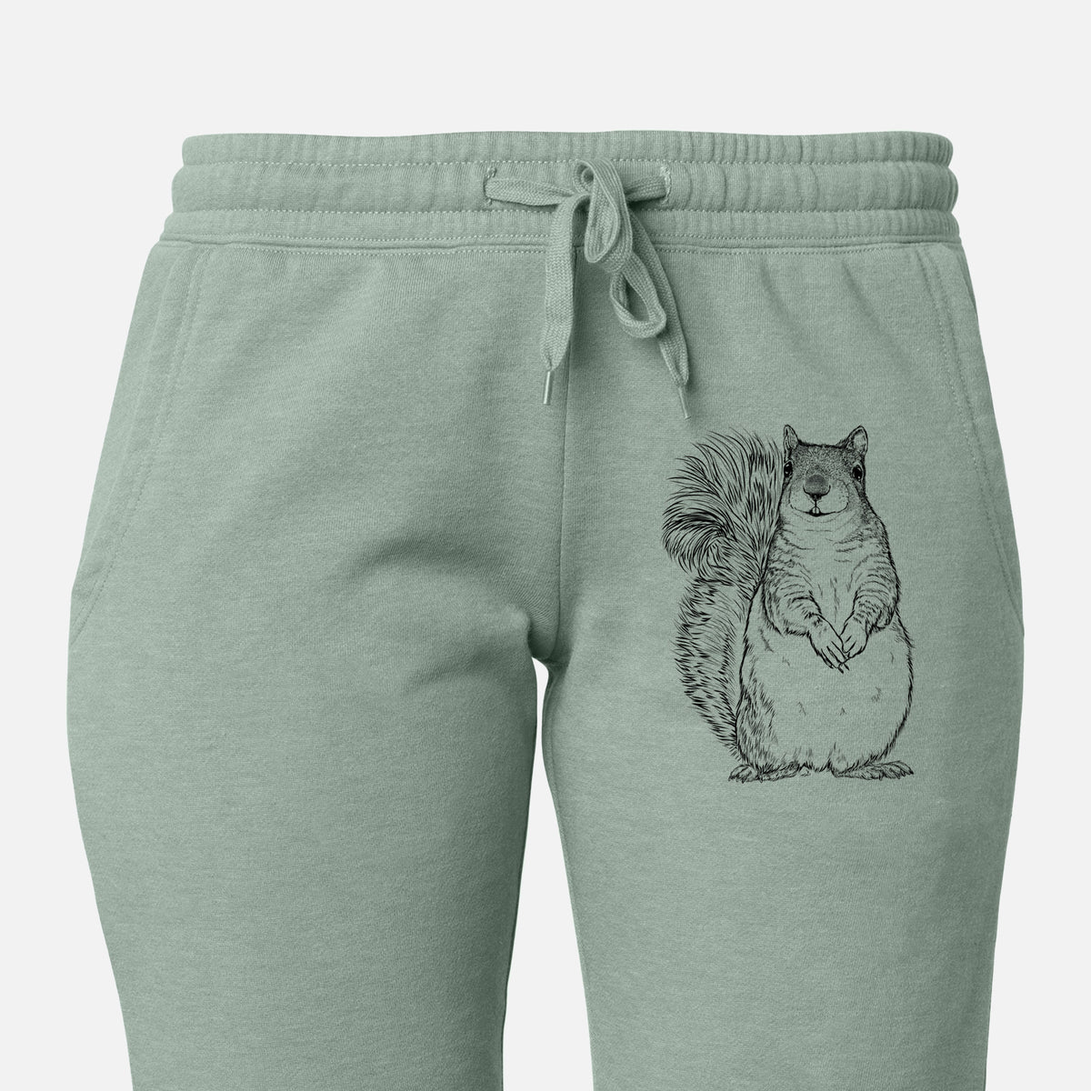 Front of sage green Cali Wave sweatpants, printed with a detailed black ink illustration of a western grey squirrel sitting upright with a bushy tail on the leg.