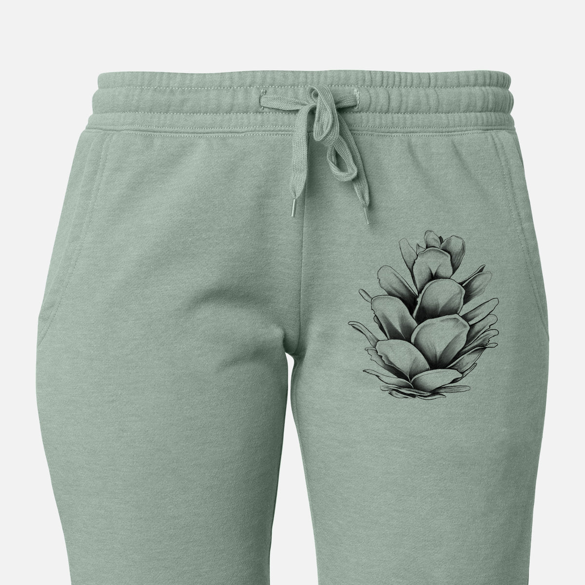 Front of sage green Cali Wave sweatpants, printed with a detailed black ink illustration of a western hemlock pine cone on the leg.