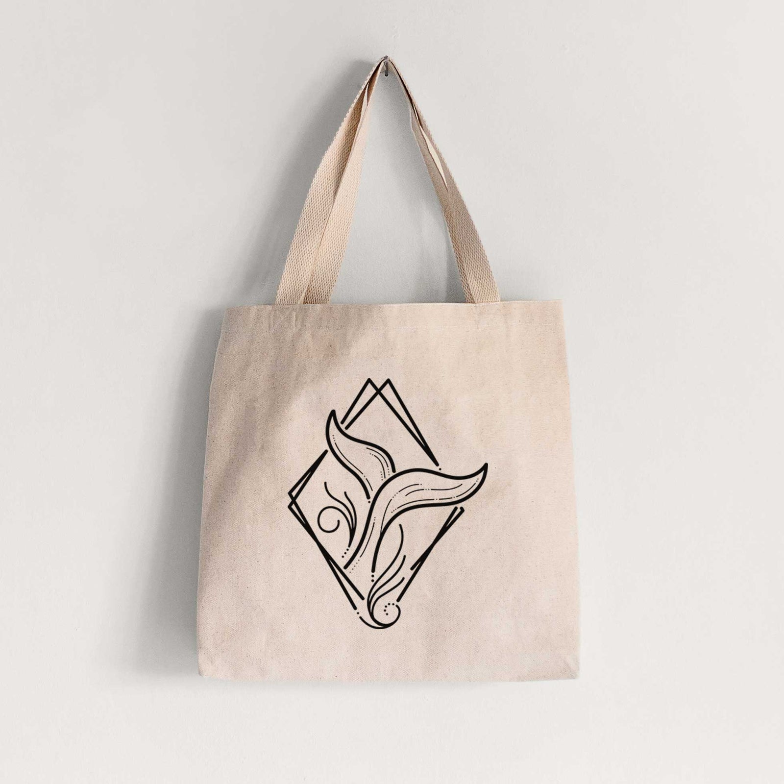 Natural canvas tote bag printed with a black line art whale tail rising from a wave inside a diamond outline.