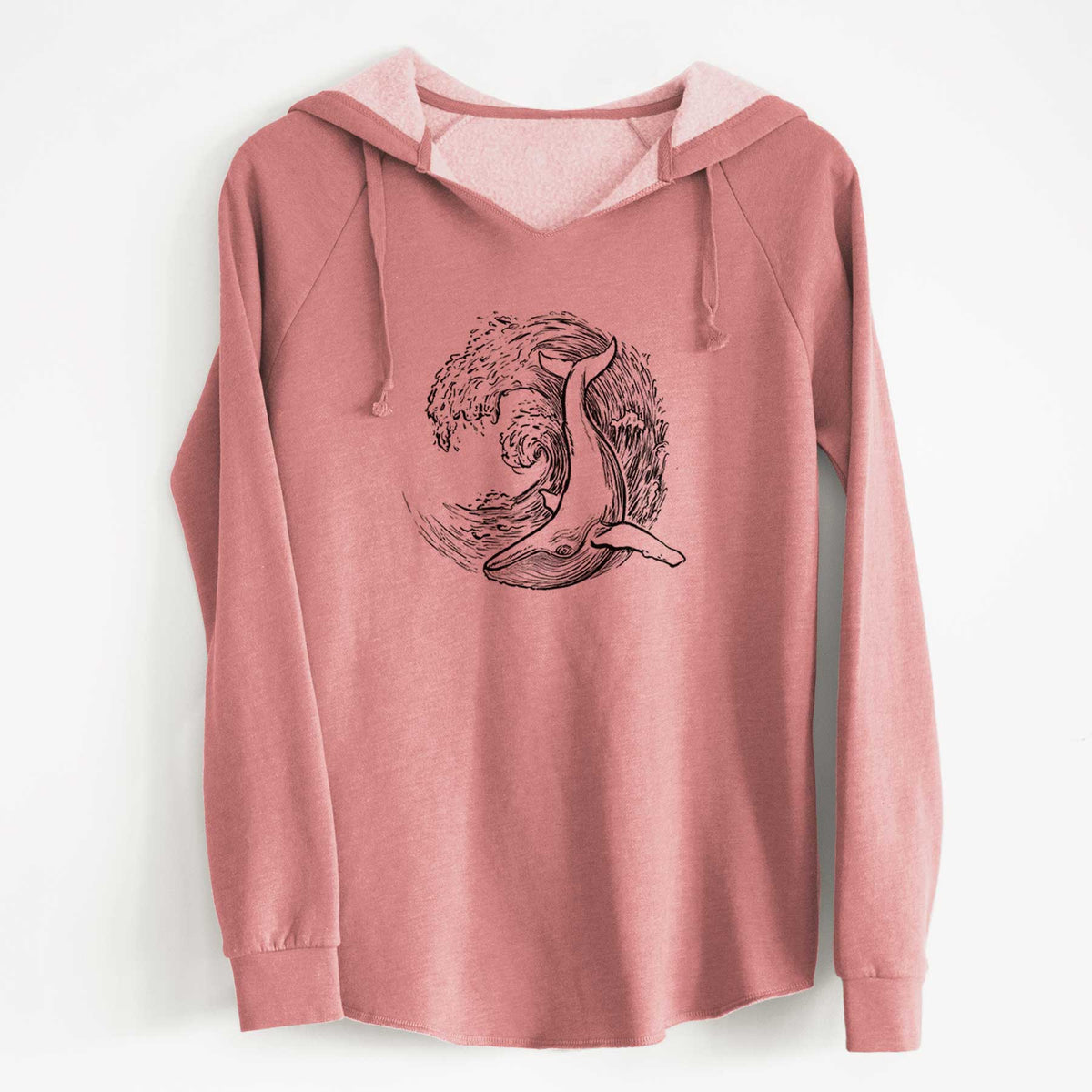 Dusty rose women's Cali Wave hooded sweatshirt laid flat, printed with a black ink illustration of a humpback whale swimming inside a curling ocean wave.
