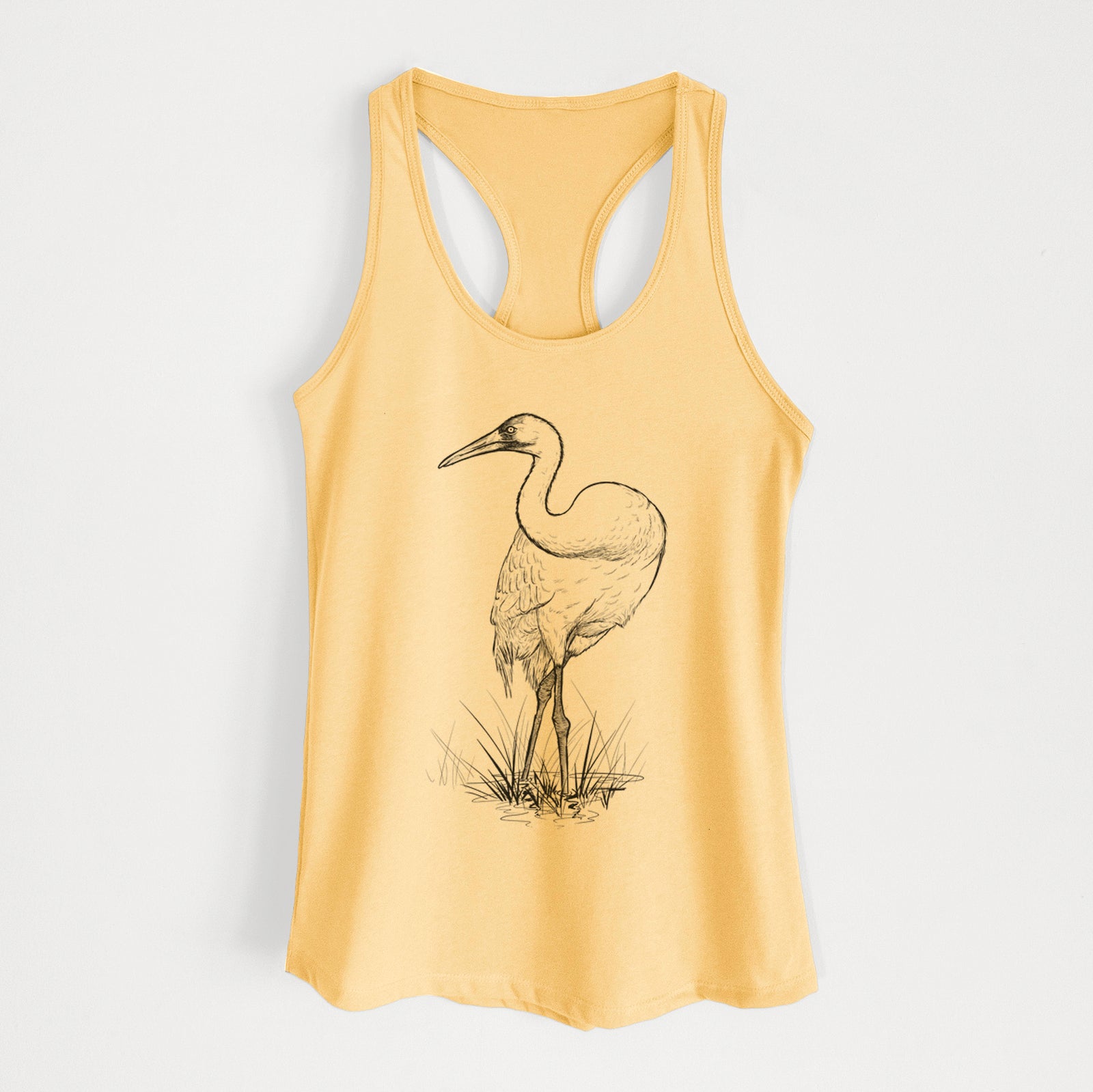 Banana cream women's racerback tank top laid flat, printed with a detailed black ink illustration of a whooping crane standing in grass.