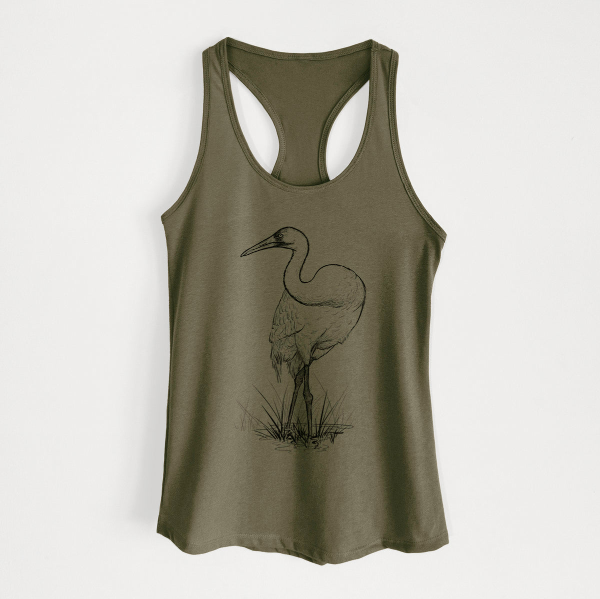 Military green women's racerback tank top laid flat, printed with a detailed black ink illustration of a whooping crane standing in grass.