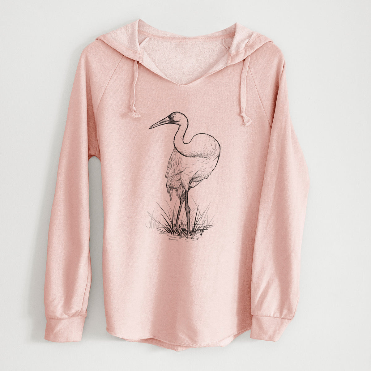 Blush pink women's Cali Wave hooded sweatshirt laid flat, printed with a detailed black ink illustration of a whooping crane standing in grass.