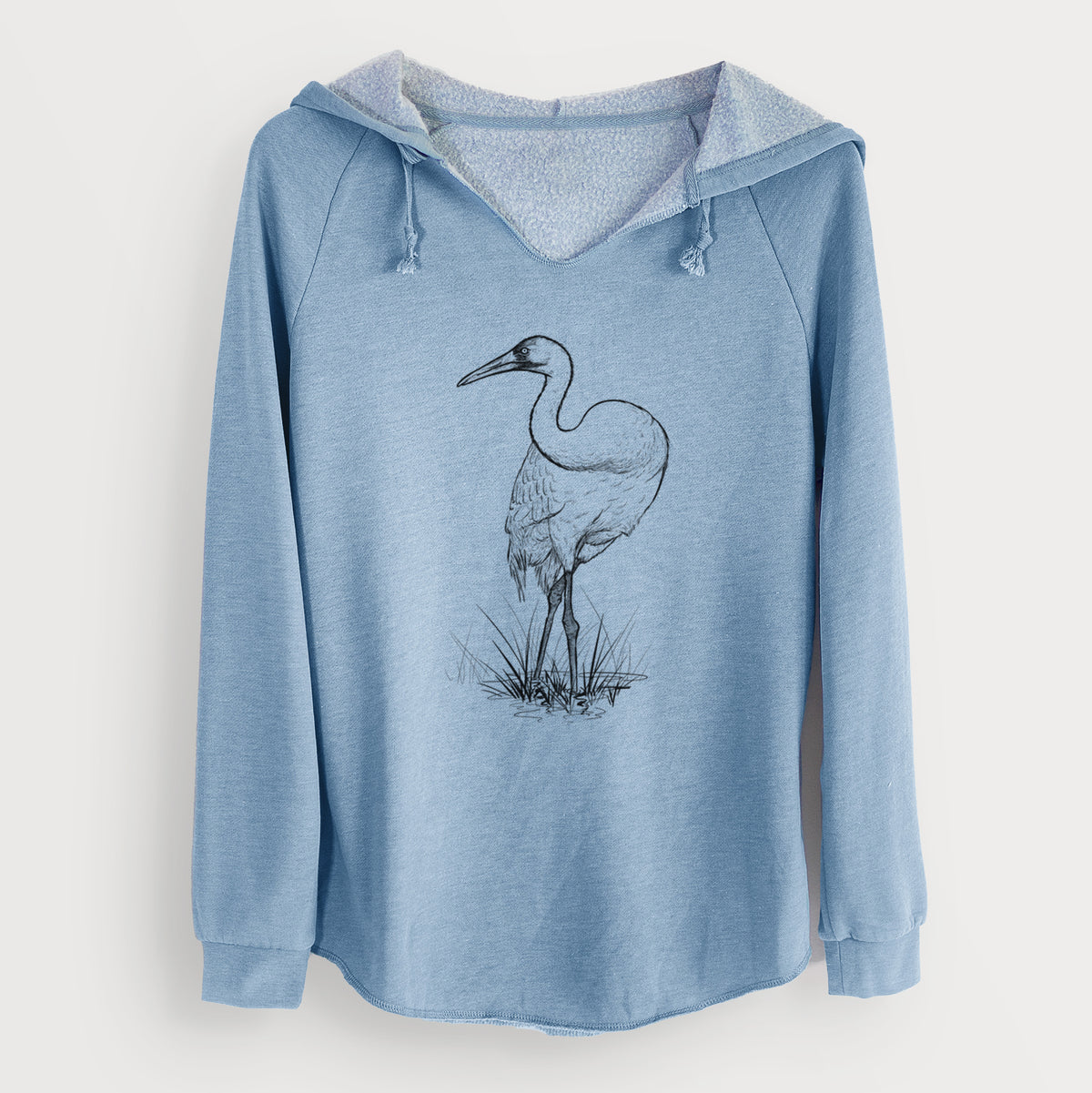 Misty blue women's Cali Wave hooded sweatshirt laid flat, printed with a detailed black ink illustration of a whooping crane standing in grass.
