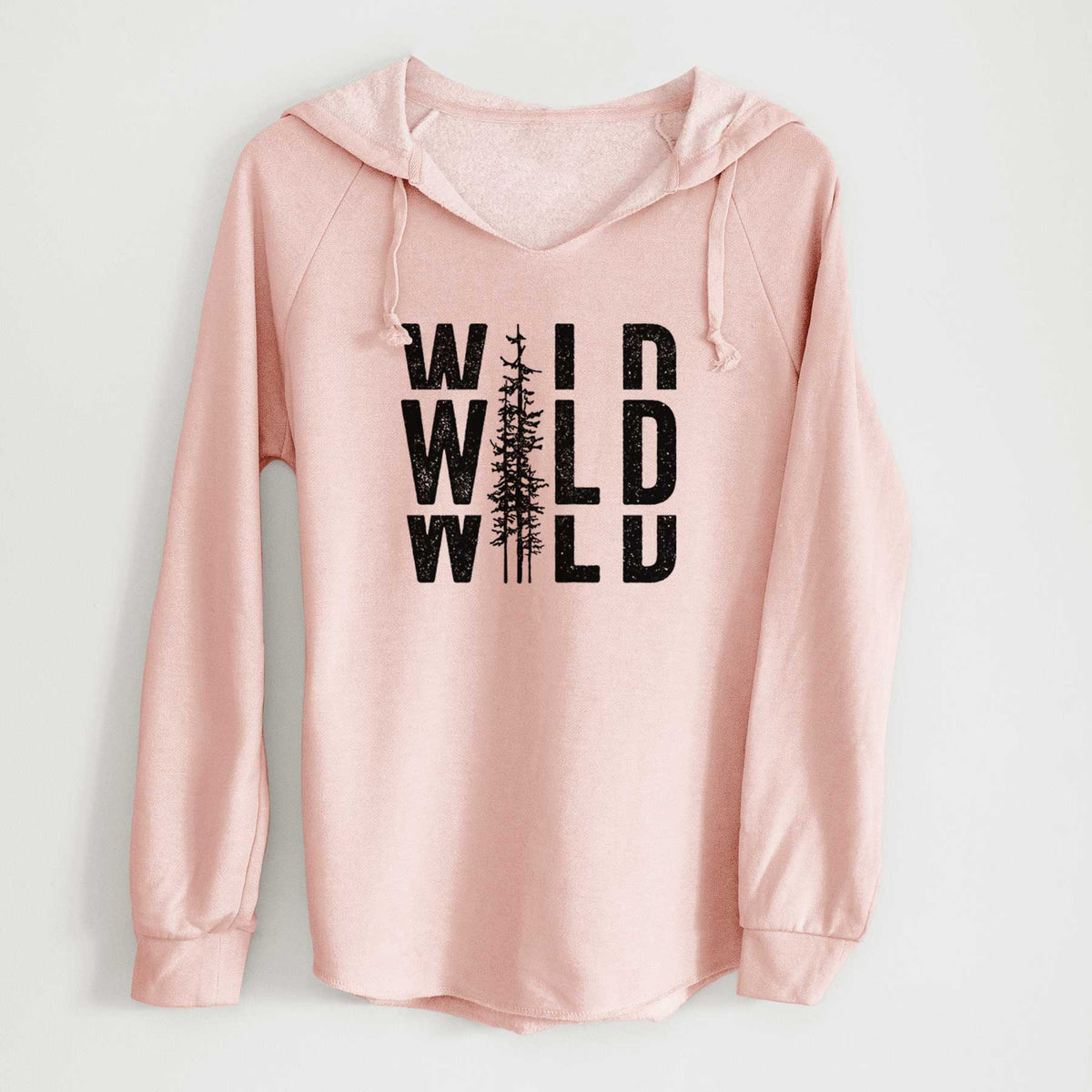 Blush pink women's Cali Wave hooded sweatshirt laid flat, printed with bold black text reading WILD stacked three times, with a tall pine tree forming the letter I.