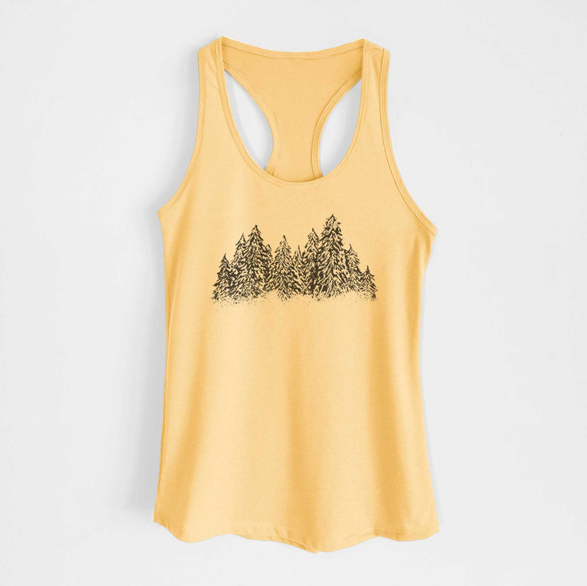 Banana cream women's racerback tank top laid flat, printed with a black ink illustration of a row of snow-dusted evergreen trees.
