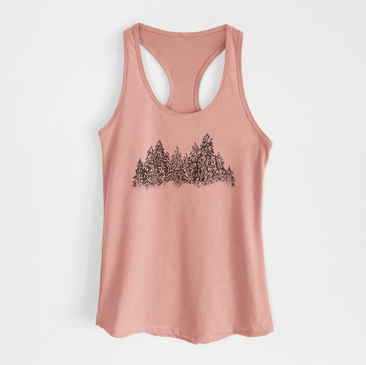 Desert pink women's racerback tank top laid flat, printed with a black ink illustration of a row of snow-dusted evergreen trees.