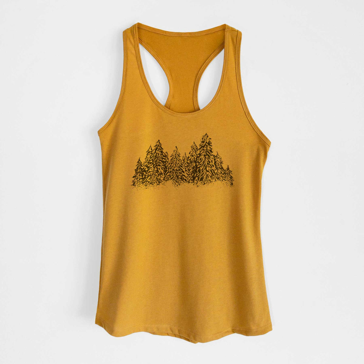 Gold women's racerback tank top laid flat, printed with a black ink illustration of a row of snow-dusted evergreen trees.