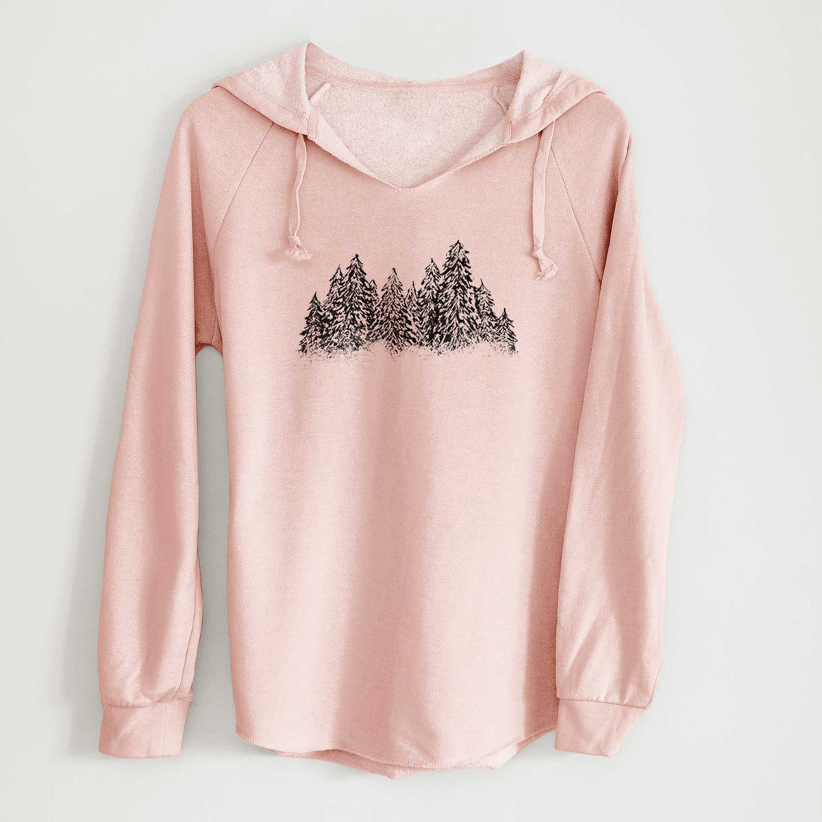Blush pink women's Cali Wave hooded sweatshirt laid flat, printed with a black ink illustration of a row of snow-dusted evergreen trees.