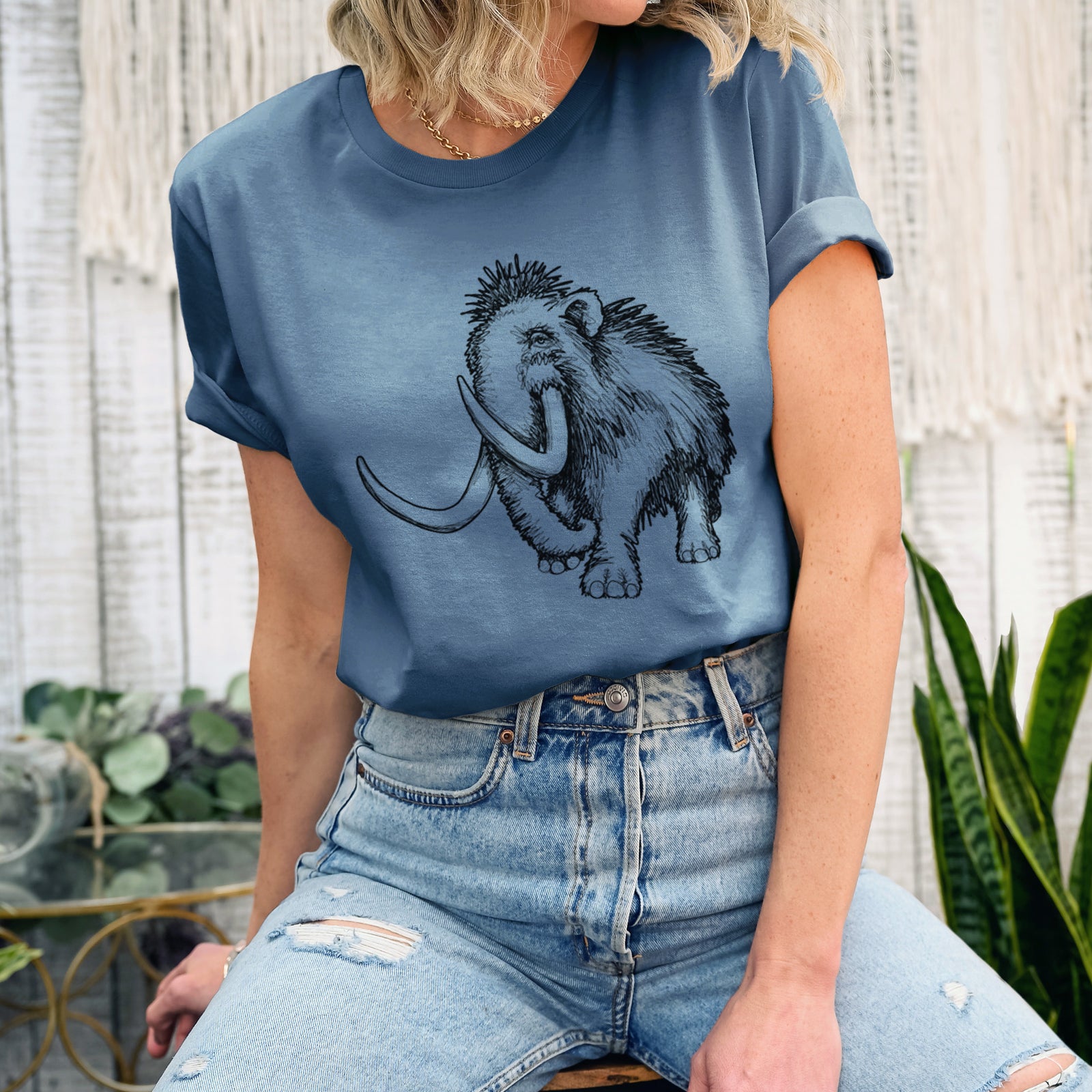 Autumn lightweight cotton t-shirt laid flat, printed with a black ink illustration of a woolly mammoth with long curved tusks.