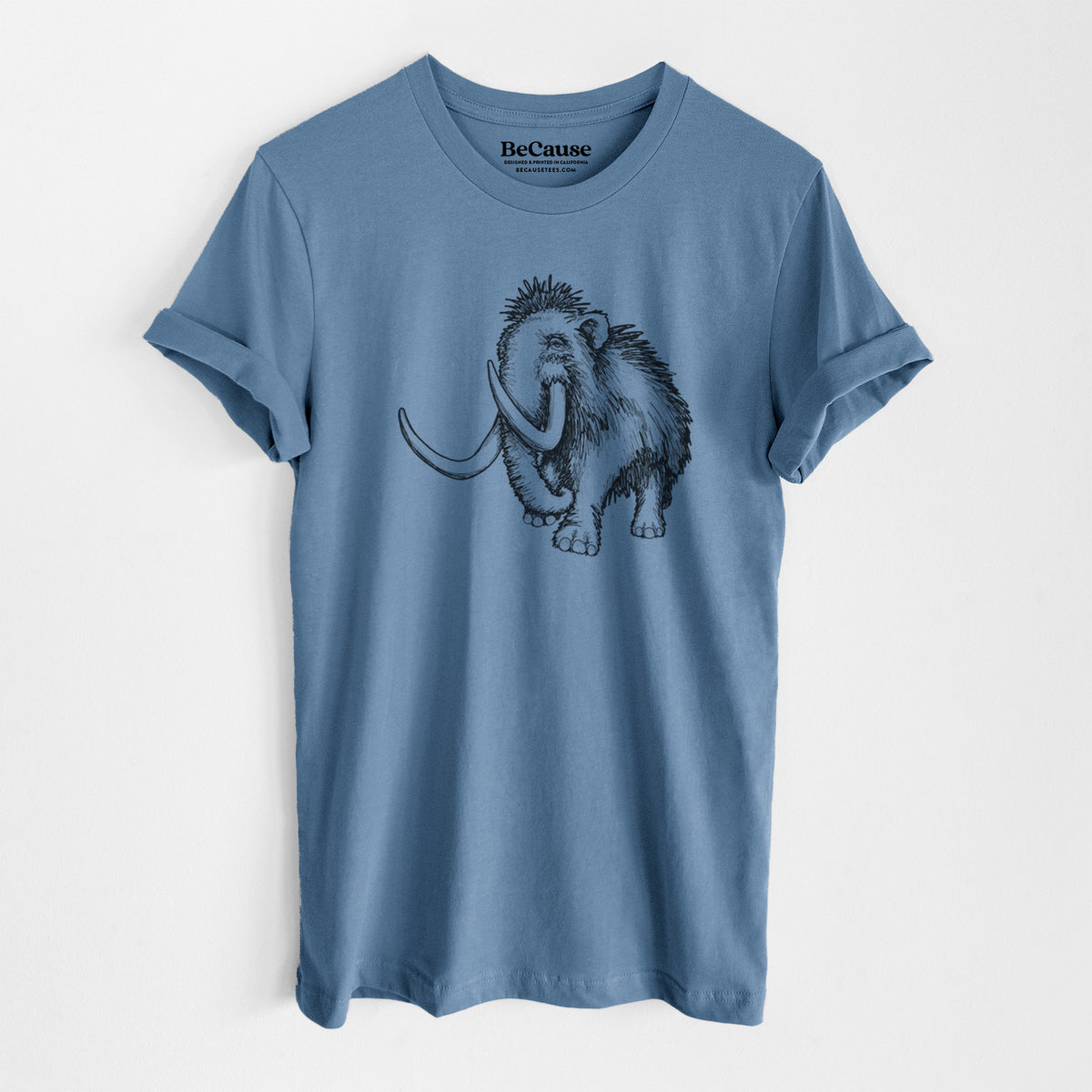 Steel blue lightweight cotton t-shirt laid flat, printed with a black ink illustration of a woolly mammoth with long curved tusks.