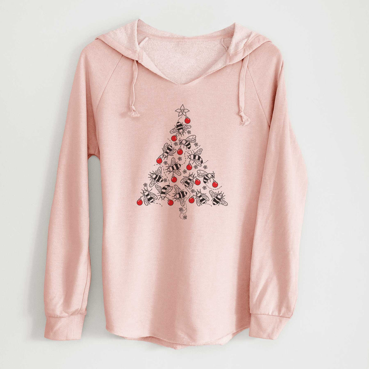 Blush pink women's Cali Wave hooded sweatshirt laid flat, printed with a Christmas tree made of black ink bees with red ornaments and a star on top.