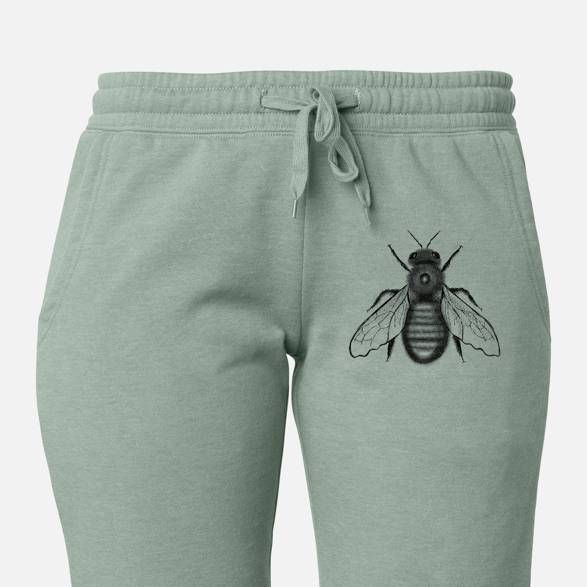 Front of sage green Cali Wave sweatpants, printed with a detailed black ink illustration of an eastern carpenter bee with its wings spread, seen from above on the leg.
