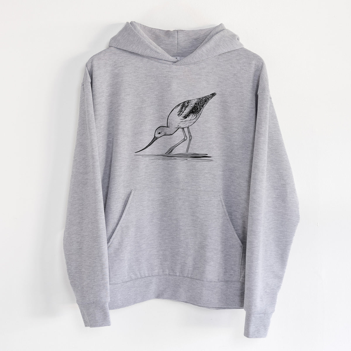American Avocet - Recurvirostra americana - Statement Midweight Hoodie in Heather Grey, hanging on a white wall, with a front kangaroo pocket and no drawcords.