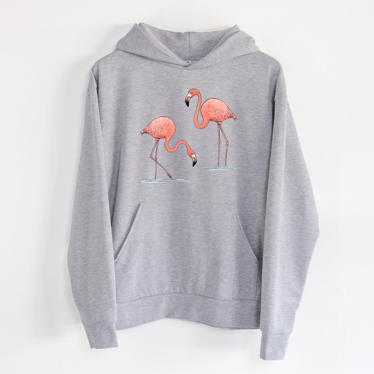 American Flamingos - Phoenicopterus ruber - Statement Midweight Hoodie in Heather Grey, hanging on a white wall, with a front kangaroo pocket and no drawcords.