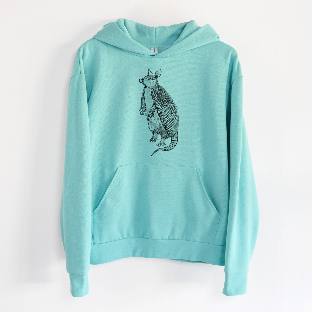 Nine-Banded Armadillo - Dasypus novemcinctus - Statement Midweight Hoodie in Seafoam, hanging on a white wall, with a front kangaroo pocket and no drawcords.