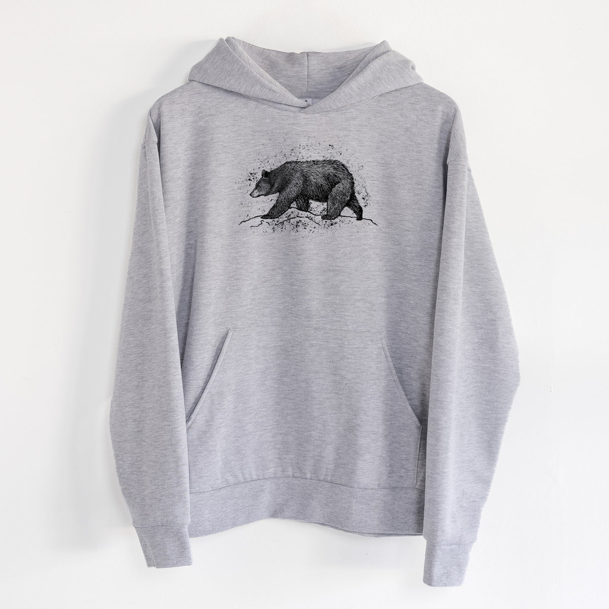 Black Bear - Statement Midweight Hoodie in Heather Grey, hanging on a white wall, with a front kangaroo pocket and no drawcords.