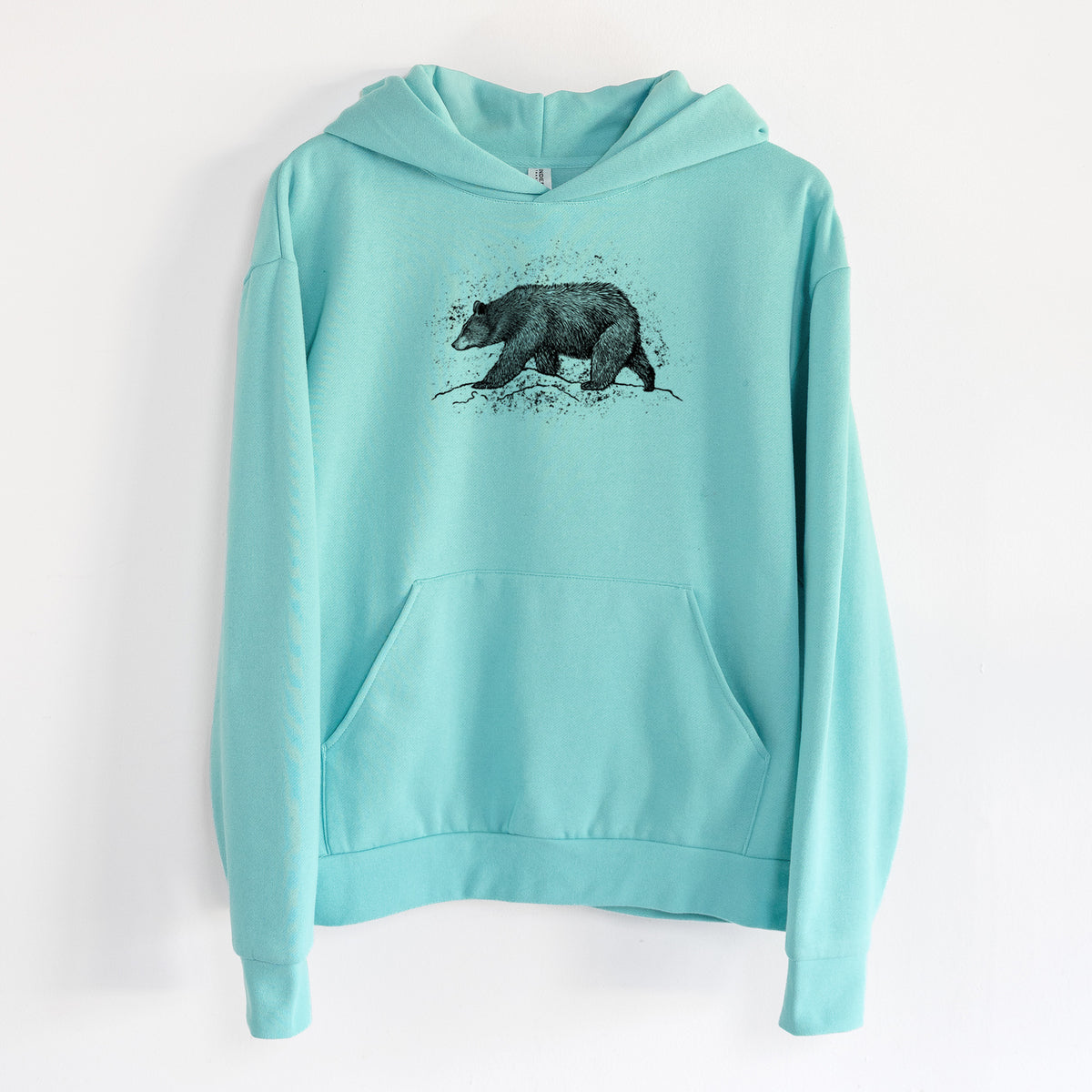 Black Bear - Statement Midweight Hoodie in Seafoam, hanging on a white wall, with a front kangaroo pocket and no drawcords.