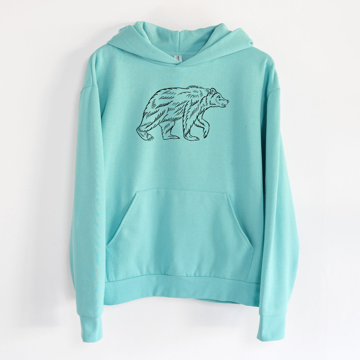 Brown Bear - Statement Midweight Hoodie in Seafoam, hanging on a white wall, with a front kangaroo pocket and no drawcords.