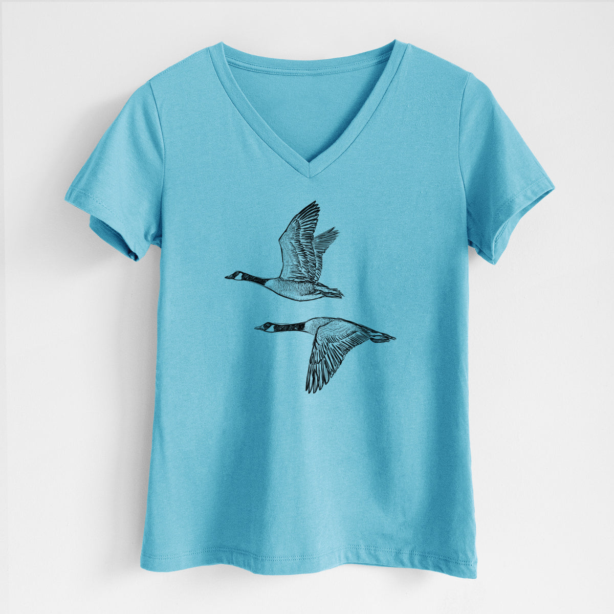 Canada Geese in Flight - Branta canadensis - Women's Lightweight Relaxed Fit 100% Cotton V-neck in Turquoise, on a hanger