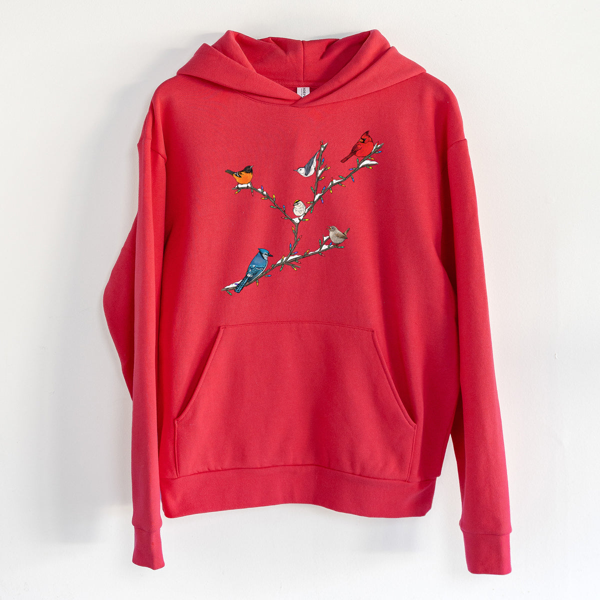 Christmas Backyard Birds - Statement Midweight Hoodie in Cherry Red, hanging on a white wall, with a front kangaroo pocket and no drawcords.