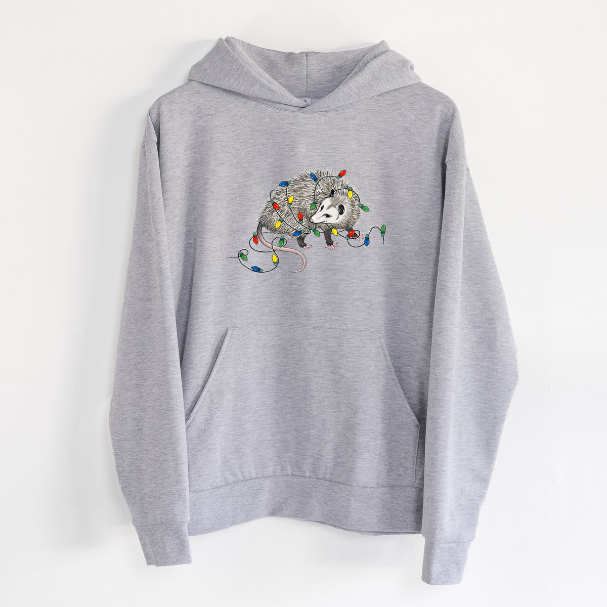 Christmas Opossum - Statement Midweight Hoodie in Heather Grey, hanging on a white wall, with a front kangaroo pocket and no drawcords.
