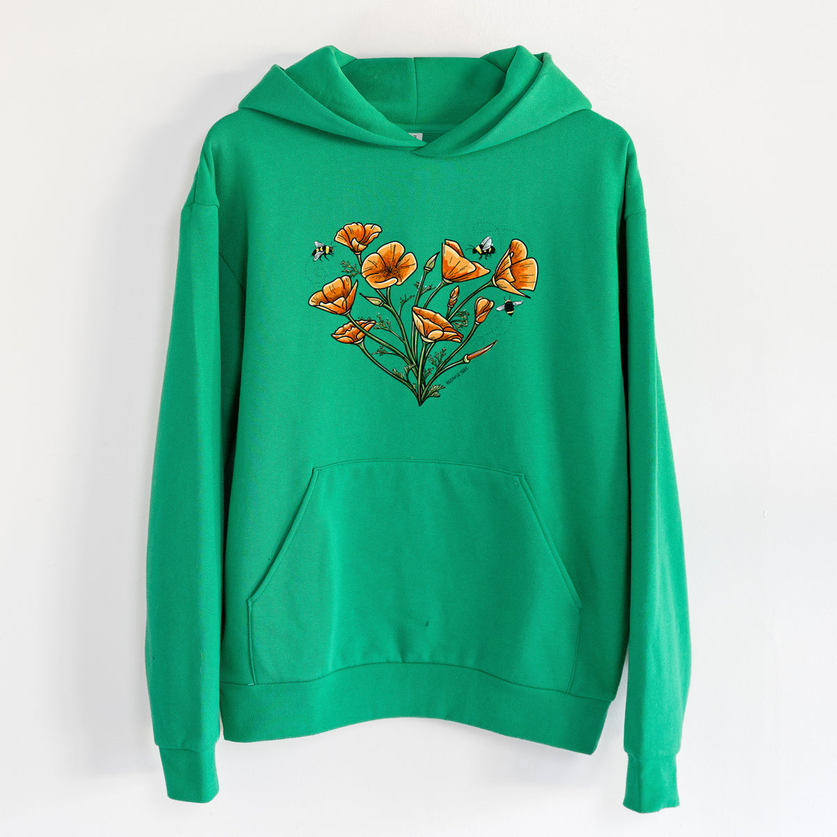 Color California Poppy Heart - Statement Midweight Hoodie in Kelly Green, hanging on a white wall, with a front kangaroo pocket and no drawcords.