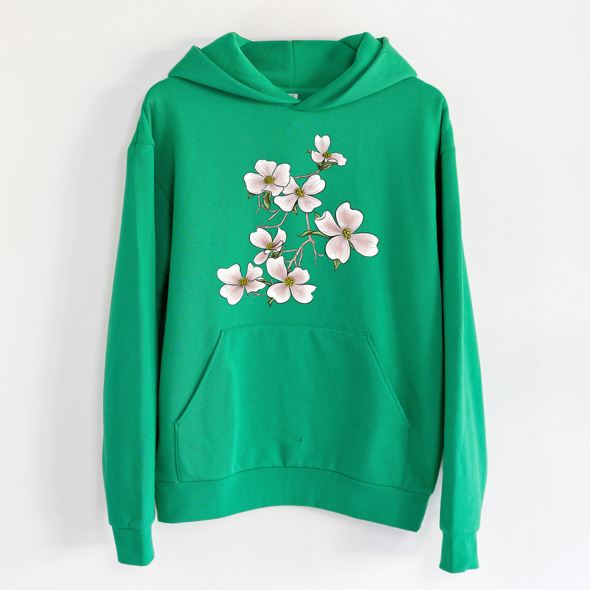 Flowering Dogwood - Cornus florida - Statement Midweight Hoodie in Kelly Green, hanging on a white wall, with a front kangaroo pocket and no drawcords.