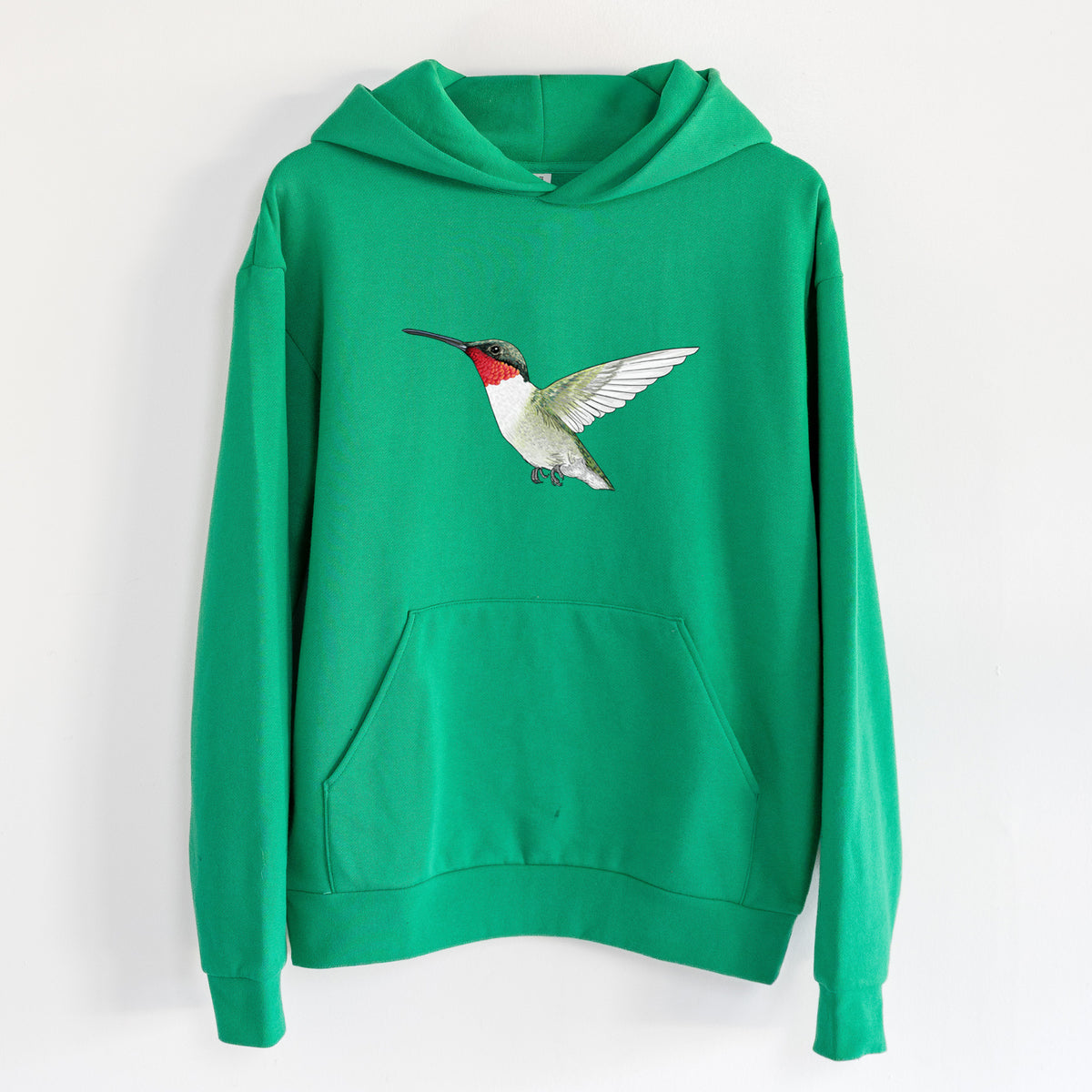 Vibrant Ruby-throated Hummingbird - Archilochus colubris - Statement Midweight Hoodie in Kelly Green, hanging on a white wall, with a front kangaroo pocket and no drawcords.