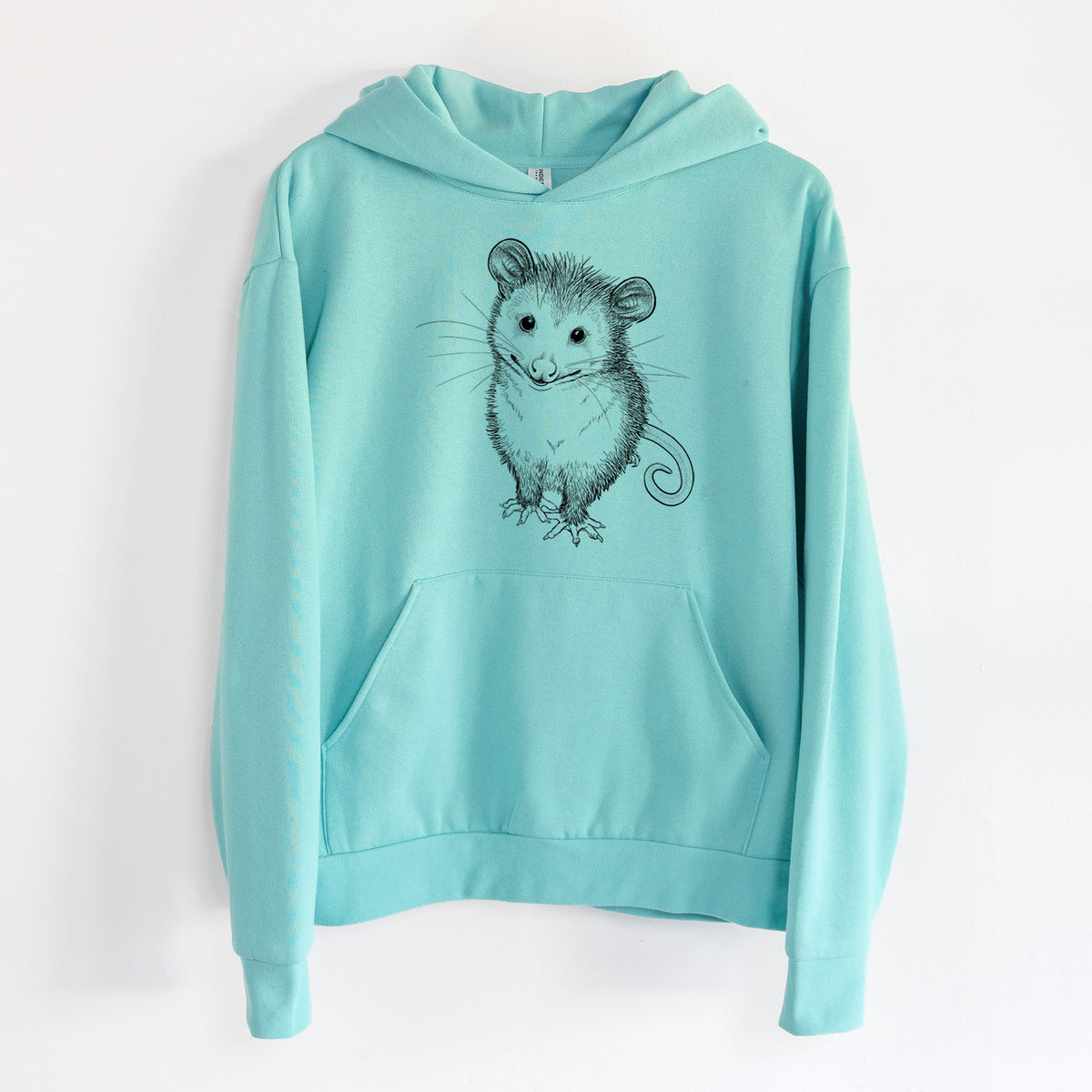 Cute Opossum - Statement Midweight Hoodie in Seafoam, hanging on a white wall, with a front kangaroo pocket and no drawcords.