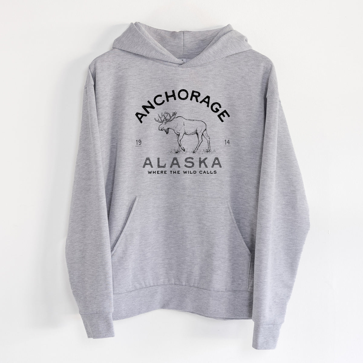 Anchorage Alaska Moose - Statement Midweight Hoodie in Heather Grey, hanging on a white wall, with a front kangaroo pocket and no drawcords.