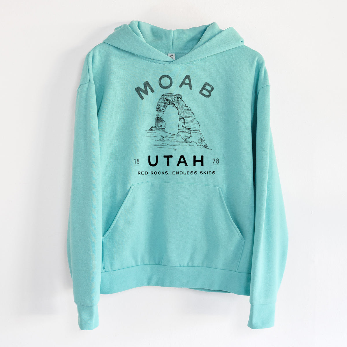 Moab Utah Delicate Arch - Statement Midweight Hoodie in Seafoam, hanging on a white wall, with a front kangaroo pocket and no drawcords.