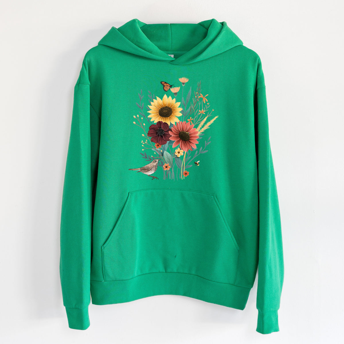 Fall Bouquet - Statement Midweight Hoodie in Kelly Green, hanging on a white wall, with a front kangaroo pocket and no drawcords.