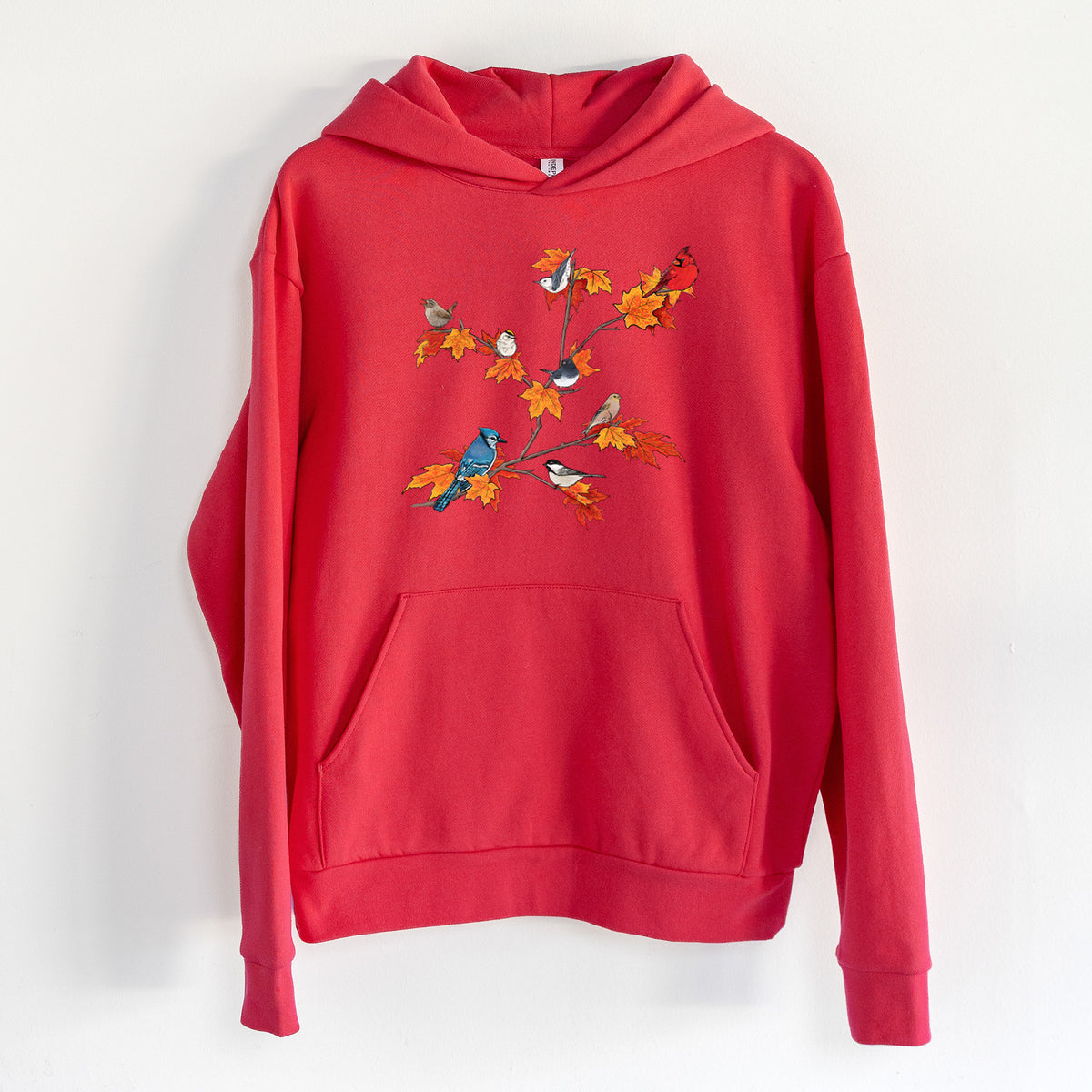 Autumn Backyard Birds - Statement Midweight Hoodie in Cherry Red, hanging on a white wall, with a front kangaroo pocket and no drawcords.
