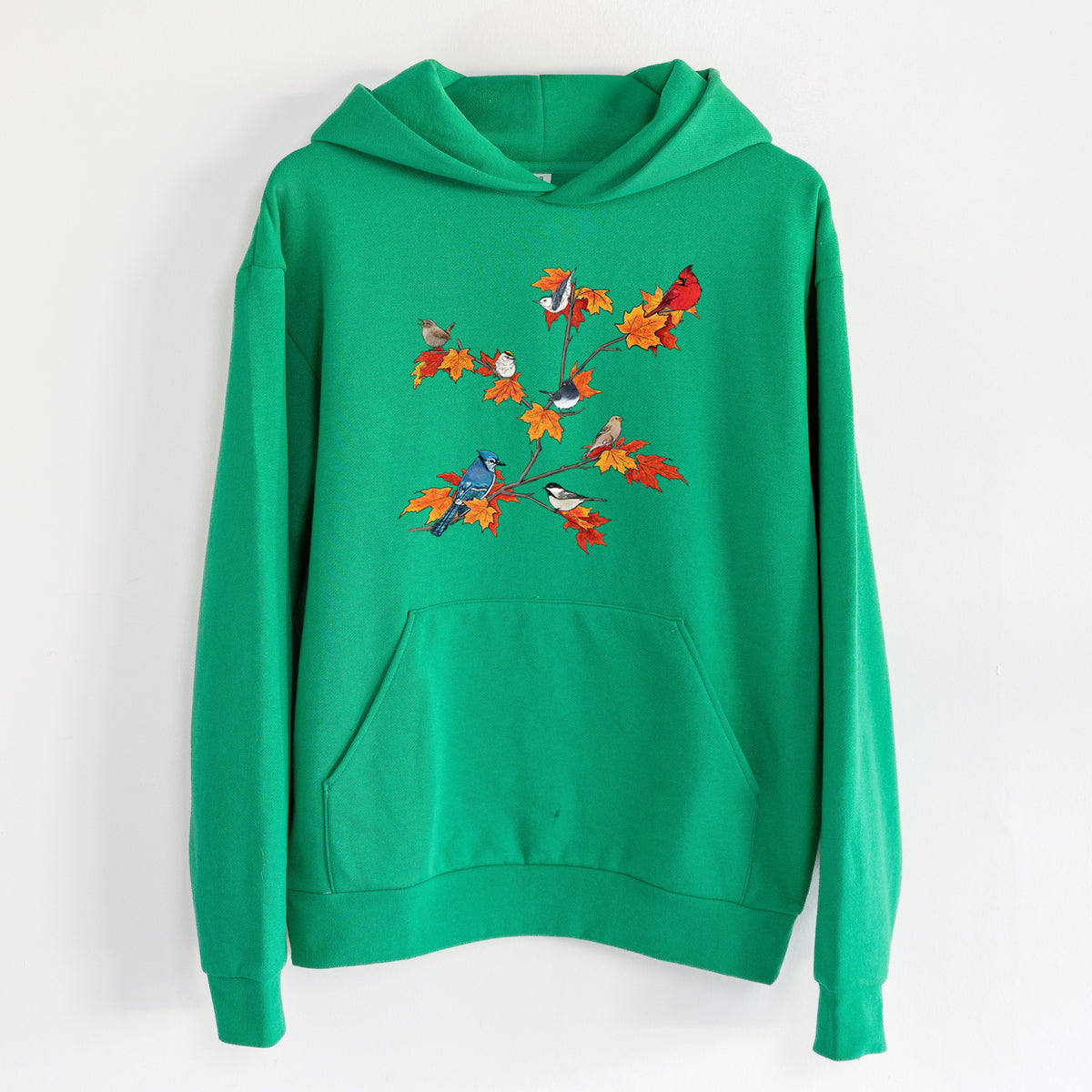 Autumn Backyard Birds - Statement Midweight Hoodie in Kelly Green, hanging on a white wall, with a front kangaroo pocket and no drawcords.