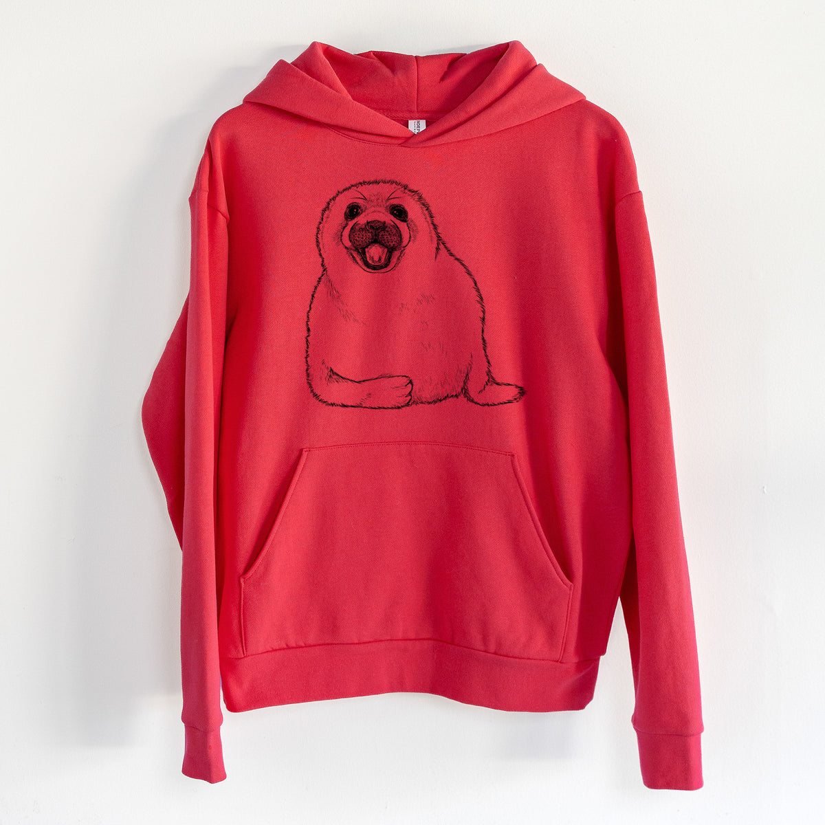 Harp Seal Pup - Pagophilus groenlandicus - Statement Midweight Hoodie in Cherry Red, hanging on a white wall, with a front kangaroo pocket and no drawcords.