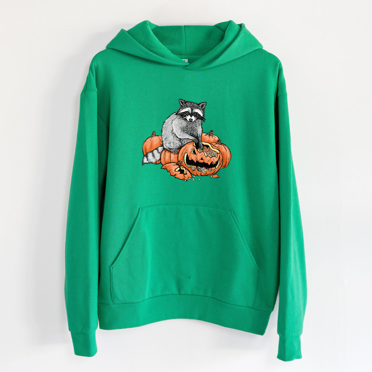 The Raccoon and the Jack-o'-Lantern - Statement Midweight Hoodie in Kelly Green, hanging on a white wall, with a front kangaroo pocket and no drawcords.