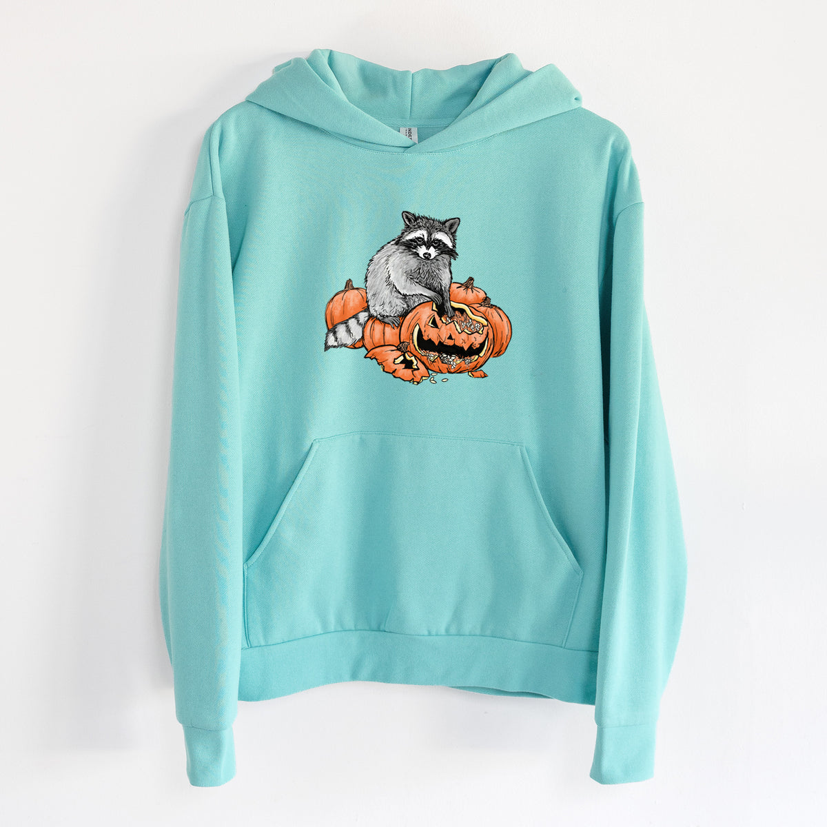 The Raccoon and the Jack-o'-Lantern - Statement Midweight Hoodie in Seafoam, hanging on a white wall, with a front kangaroo pocket and no drawcords.