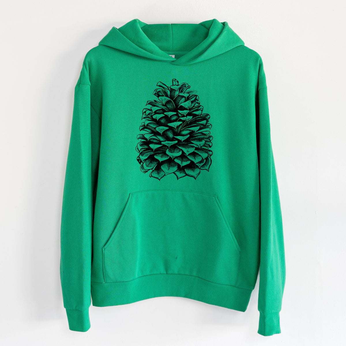 Pinus Jeffreyi - Jeffrey Pine Cone - Statement Midweight Hoodie in Kelly Green, hanging on a white wall, with a front kangaroo pocket and no drawcords.
