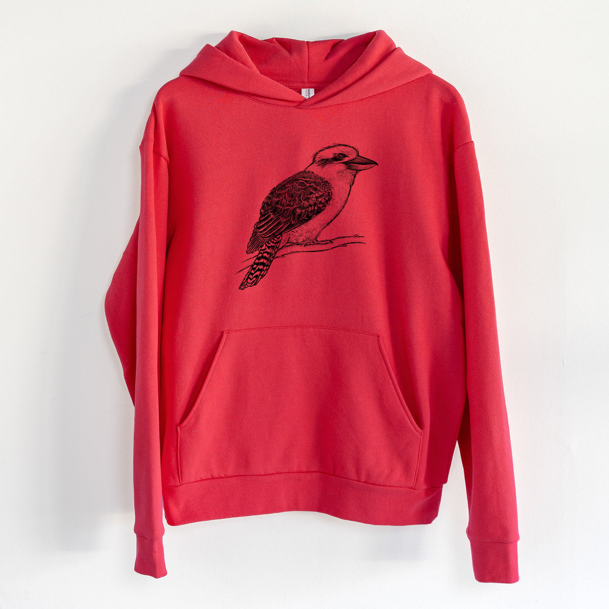 Kookaburra - Dacelo novaeguineae - Statement Midweight Hoodie in Cherry Red, hanging on a white wall, with a front kangaroo pocket and no drawcords.