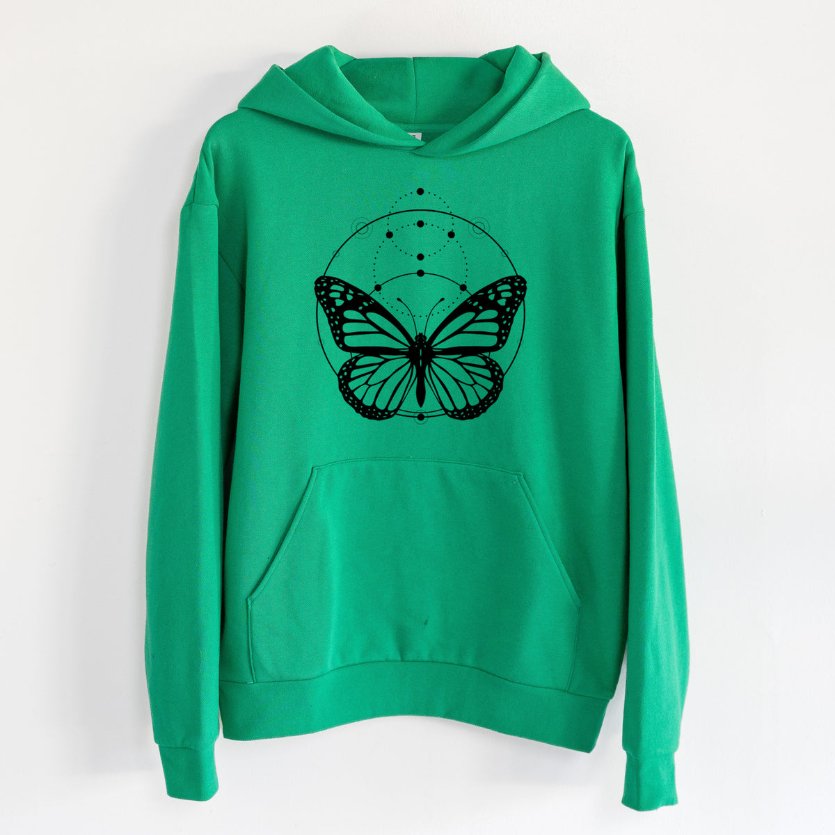 Monarch Symmetry - Statement Midweight Hoodie in Kelly Green, hanging on a white wall, with a front kangaroo pocket and no drawcords.