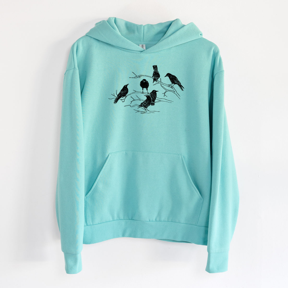 Murder of Crows - Statement Midweight Hoodie in Seafoam, hanging on a white wall, with a front kangaroo pocket and no drawcords.