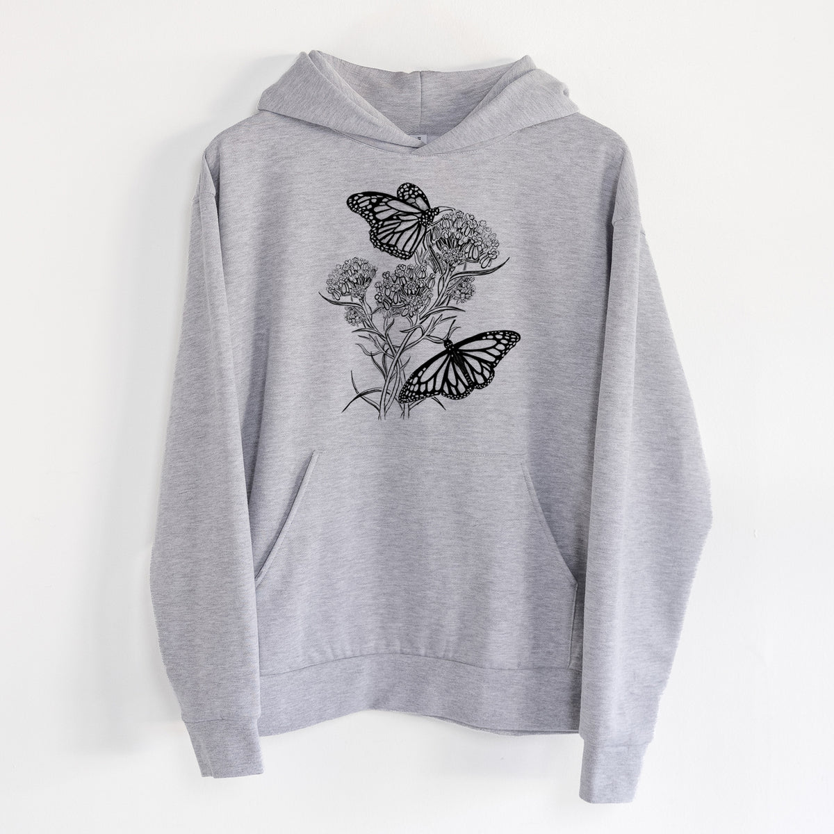 Narrowleaf Milkweed with Monarchs - Statement Midweight Hoodie in Heather Grey, hanging on a white wall, with a front kangaroo pocket and no drawcords.