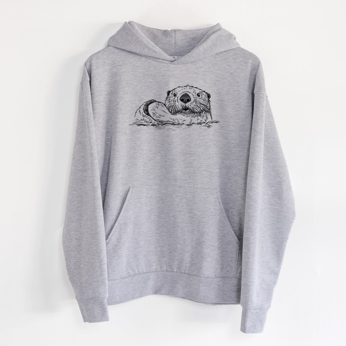 Northern Sea Otter - Enhydra lutris kenyoni - Statement Midweight Hoodie in Heather Grey, hanging on a white wall, with a front kangaroo pocket and no drawcords.